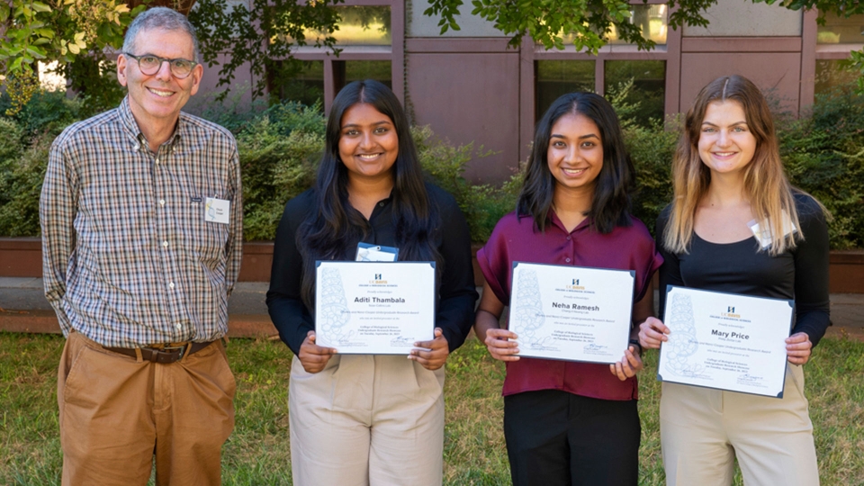 Charles Cooper stands next to three students who were recipients of an undergraduate research award funded by him and his wife, Nancy.