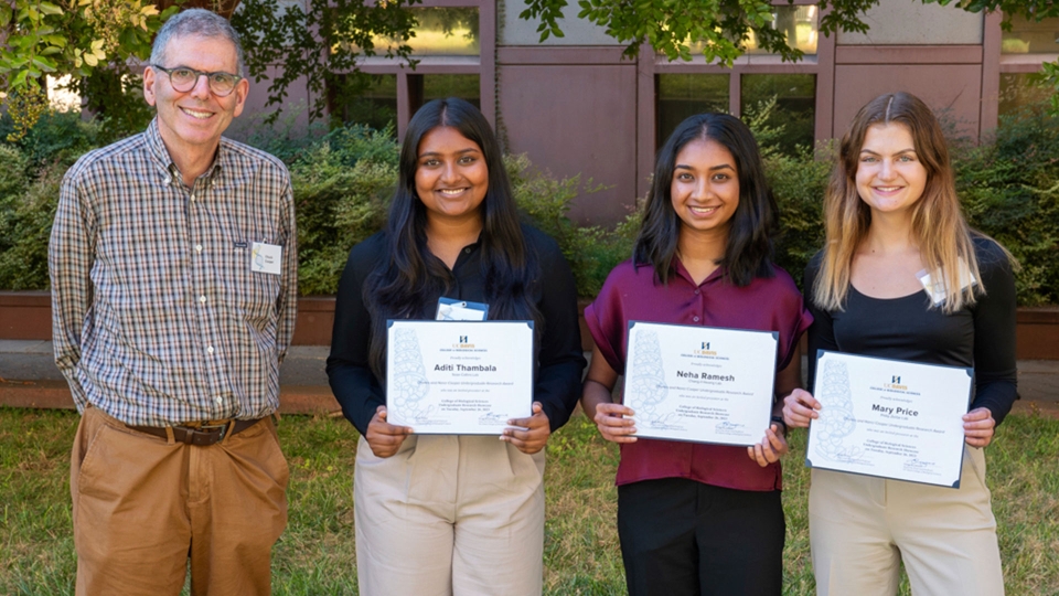 Charles Cooper stands next to three students who were recipients of an undergraduate research award funded by him and his wife, Nancy.  